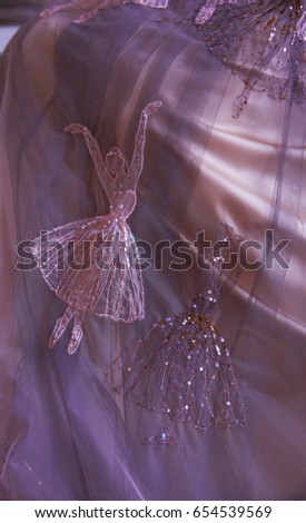 Detail of very tender tulle cloth with stitching picture of ballerina dancing.