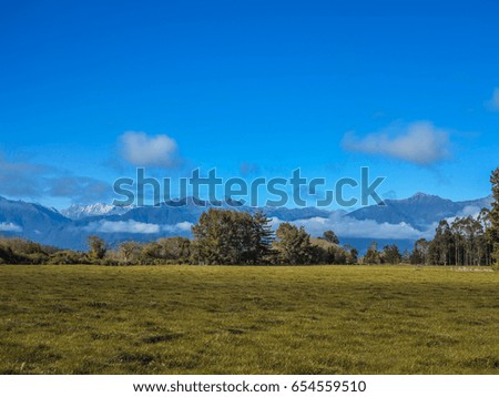 Blue sky and large green fields.