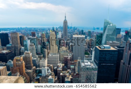 Blurred image of Empire States building and the city in the central Manhattan Island, New York city in the summer day