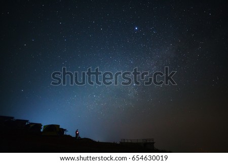 Landscape with milky way, Night sky with stars and silhouette of a standing man on Phutabberk Phetchabun in Thailand
