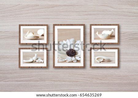 Photo frames set with abstract floral motif pictures on wooden wall, interior decor wallpaper mockup