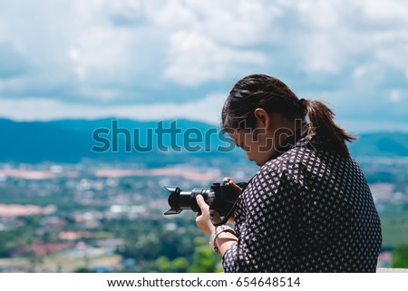 back view. asia photographer standing on top of mountain. he using camera for taking photo cloud sea in morning. this image for nature,portrait and travel concept