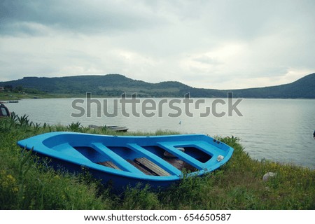 Blue boat on the shore of a lake