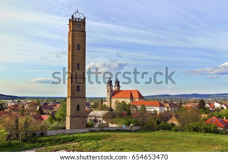 Tata, Hungary - April 16, 2017:40 meter-high Jakab Fellner lookout tower at baroque Calvary Hill of Tata,was originally a shut-tower.At the background The Holy Cross Church built in by Jakab Fellner.