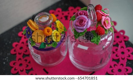 Cute glass jars decorated with polymer clay flowers of roses, raspberries, blackberries, tapes  and pansies.