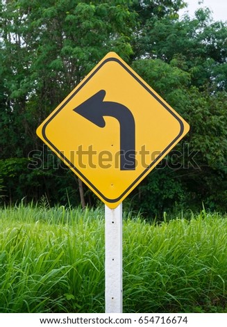 Turning Left Signage On Green Meadow Background