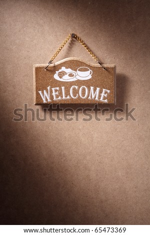 Welcome sign hung on background.