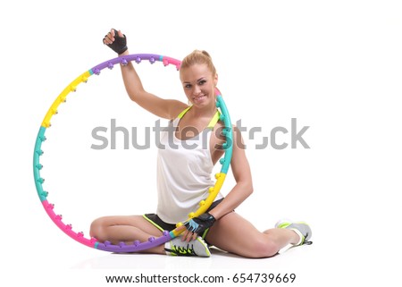 young sporty woman with hula hoop on a white background