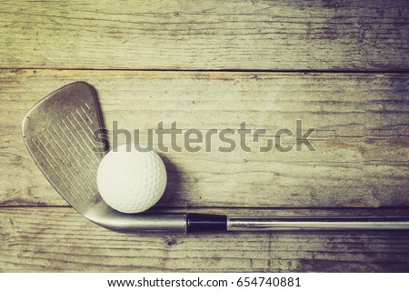Golf ball on wood table, retro style