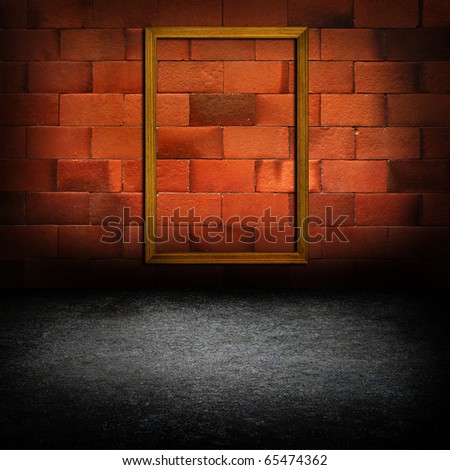 picture frames on red brick wall