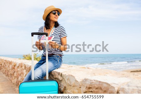 young woman sitting in front of the sea Royalty-Free Stock Photo #654755599