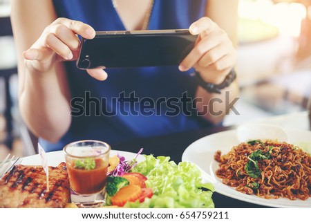 Close-up Woman hands use pointing finger Mobile smart Phone on Food table, technology and home concept