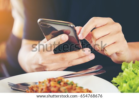 Close-up Man's hands use pointing finger Mobile smart Phone on Food table, technology and home concept