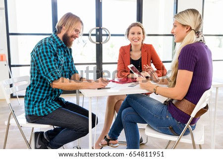 Young office workers discussing