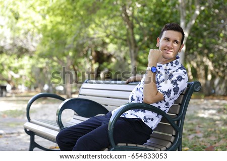 Stock photo of a young happy man smiling and glancing over his shoulder