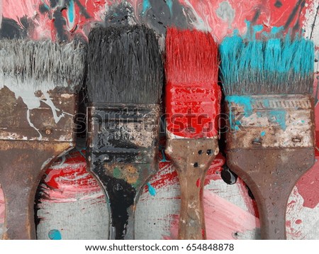 old brushes with paint on metal, galvanized metal profile