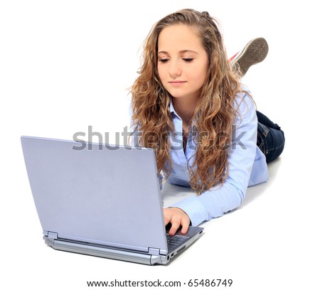 Attractive young girl lying on floor using notebook computer. All on white background.