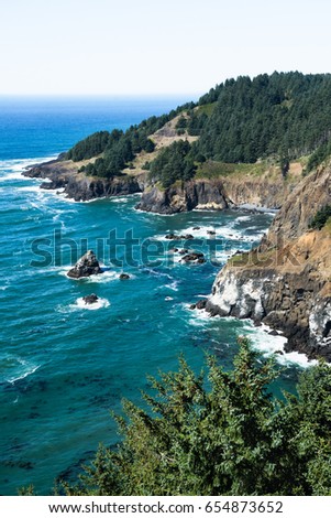 Aqua marine colors against sloping cliffs along the Pacific Ocean on the Oregon Coat. Rich and vibrant colors are achieved using a polarizing lens. 