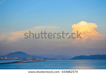 Penang Bridge with beautiful sunset colors and Mertajam Hill in backgrounds