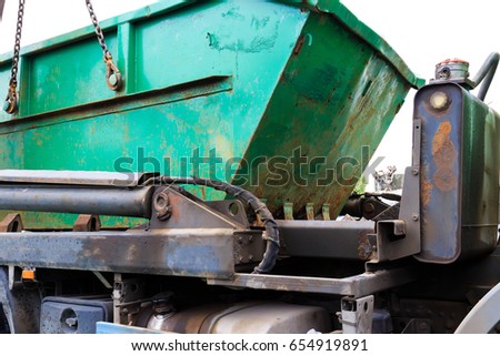 Construction waste container on a truck Royalty-Free Stock Photo #654919891