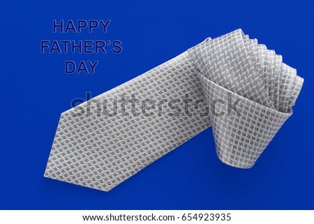 Gray silver men's Tie on a dark blue background. Happy Father's Day. Greeting card. Dad Gift.