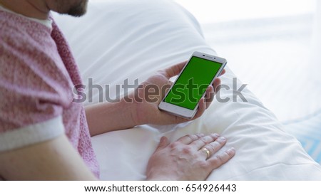 The smartphone in the hands of a man