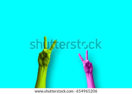 two hands making the peace sign in a colorful pop art style