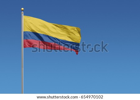 Columbia Flag in front of a clear blue sky Royalty-Free Stock Photo #654970102