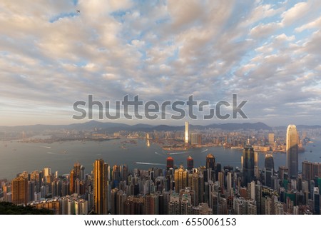 Hong Kong city view in sunset over Victoria Harbor as viewed on Victoria Peak