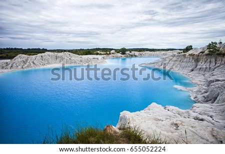 Exotica of Blue and Green Kaolin Lake in Bangka, Bangka Belitung, Indonesia. This lake is a former tin mining excavation area which is widely found on Bangka Island. Royalty-Free Stock Photo #655052224