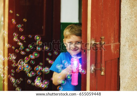the boy blow bubbles . The concept of children's summer games