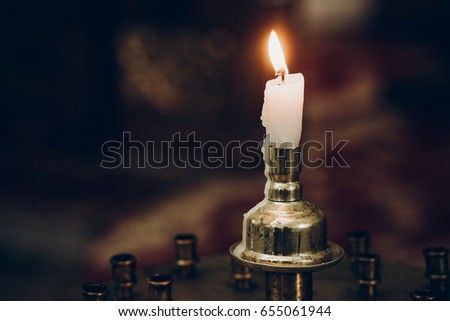 candle light, flaming on altar in church. wedding ceremony, holy moment. mourning. hope