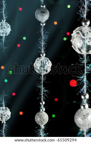 Silver christmas balls with a colorful lights on the black background