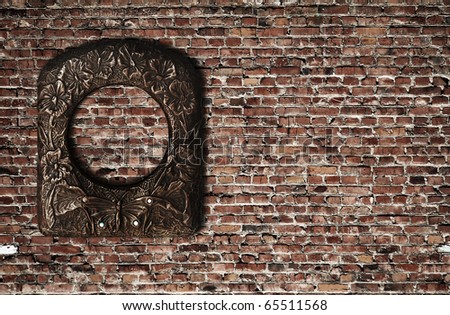 blank photo frame on old brick wall