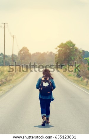 Women walk alone on the street.