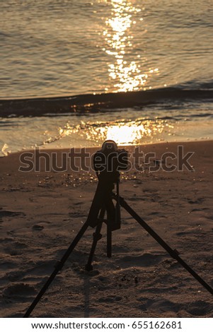 Camera on a tripod to take pictures of the sun and landscape