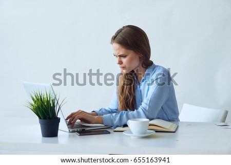 Business woman working behind laptop, woman in office                               