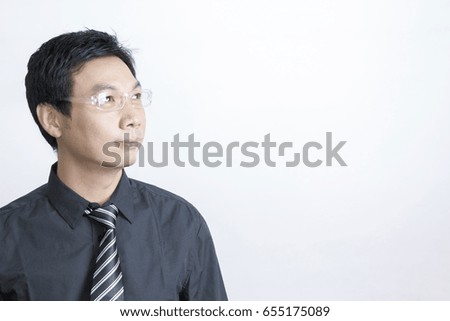 Portrait of Asian businessman standing on grey background