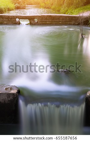 Long exposure of water stream and rocks. small waterfall with motion blur