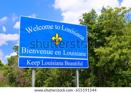 Welcome to / Bienvenue en Louisiana sign next to highway Royalty-Free Stock Photo #655191544