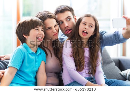 Family taking photo of themselves 
