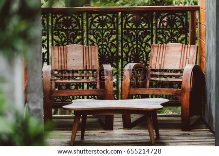 wooden chair and table in vintage house decoration with tree. Vintage loft decoration