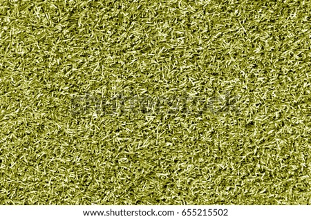 Yellow color decorative grass loan for sport and leisure. Abstract background and texture.