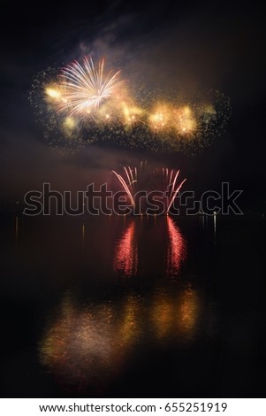 Beautiful colorful fireworks on the water surface with a clean black background. Fun festival and international contest of Firefighters - Ignis Brunensis 2017. Brno Dam - Czech Republic.