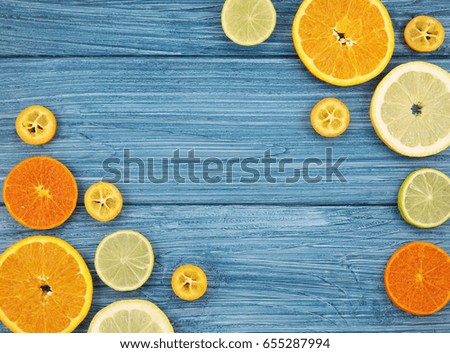 Colorful citrus fruit corners on blue wooden background. Top view.