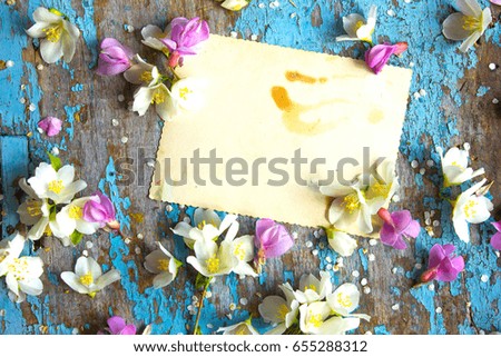 Festive white flower jasmine on the white wooden background. Overhead view. Woman working desk. Flat lay styling.