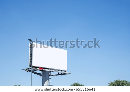 Empty billboard against a blue sky