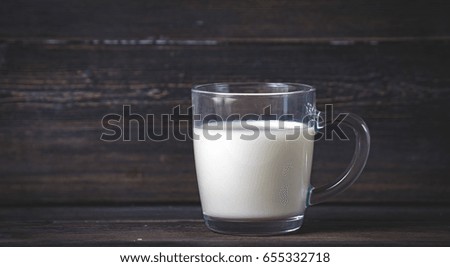 milk mug on a dark wooden boards