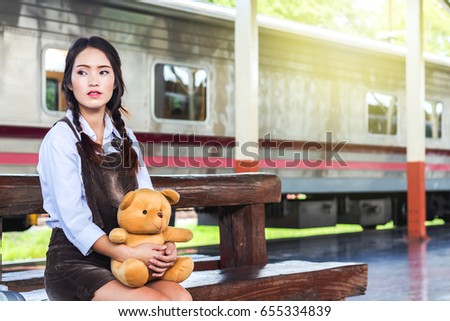 Traveling with a girl train with a brown bear