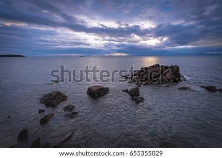 Sea reefs, the sea and clouds.